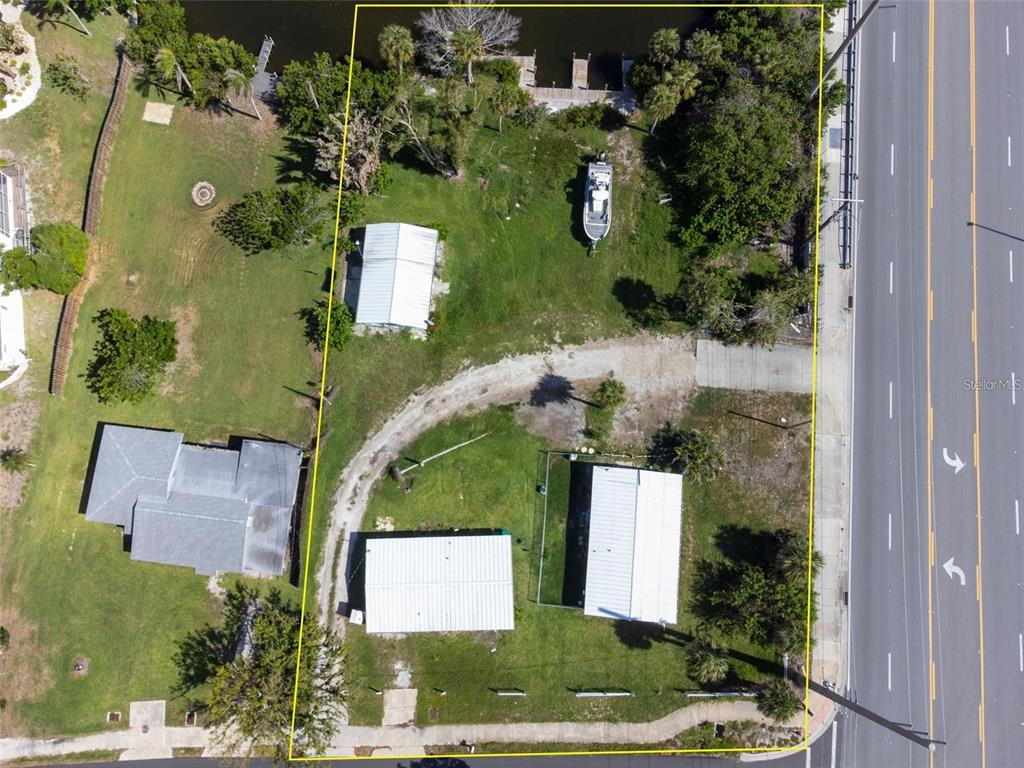 1695 Manor Road Englewood, FL 34223 - Photo 4 of 37 an aerial view of a house with a yard and lake view