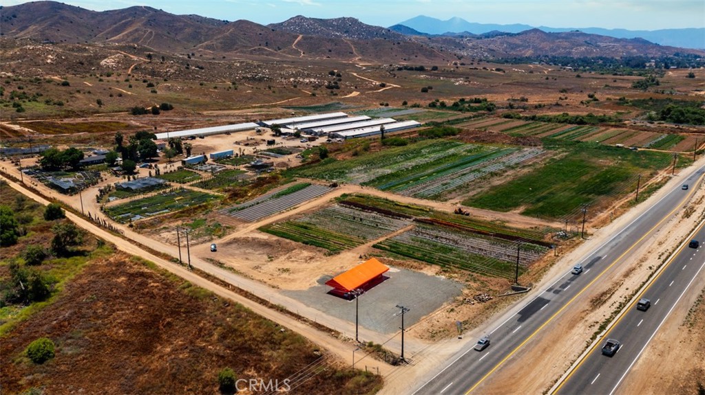 19203 Cajalco Road Perris, CA 92570 - Photo 3 of 14 an aerial view of residential houses and outdoor space