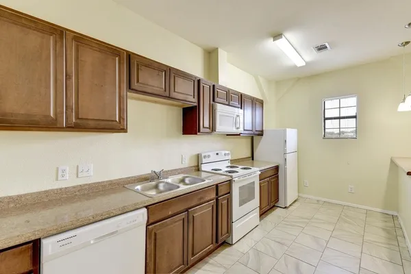 a kitchen with stainless steel appliances granite countertop a sink and a stove top oven