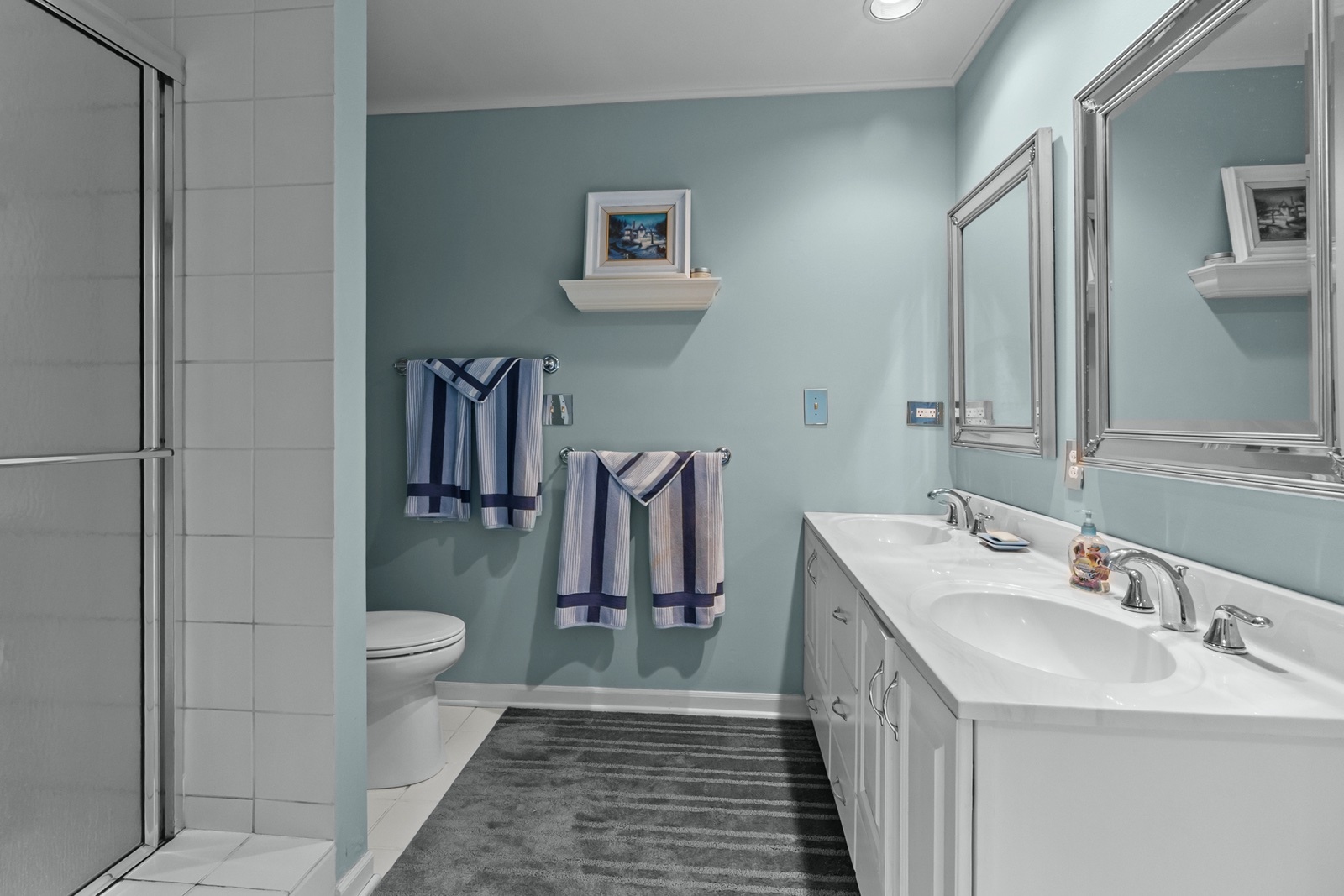 8612 Crystal Springs Road Woodstock, IL 60098 - Photo 18 of 45 a bathroom with a sink a toilet and a mirror