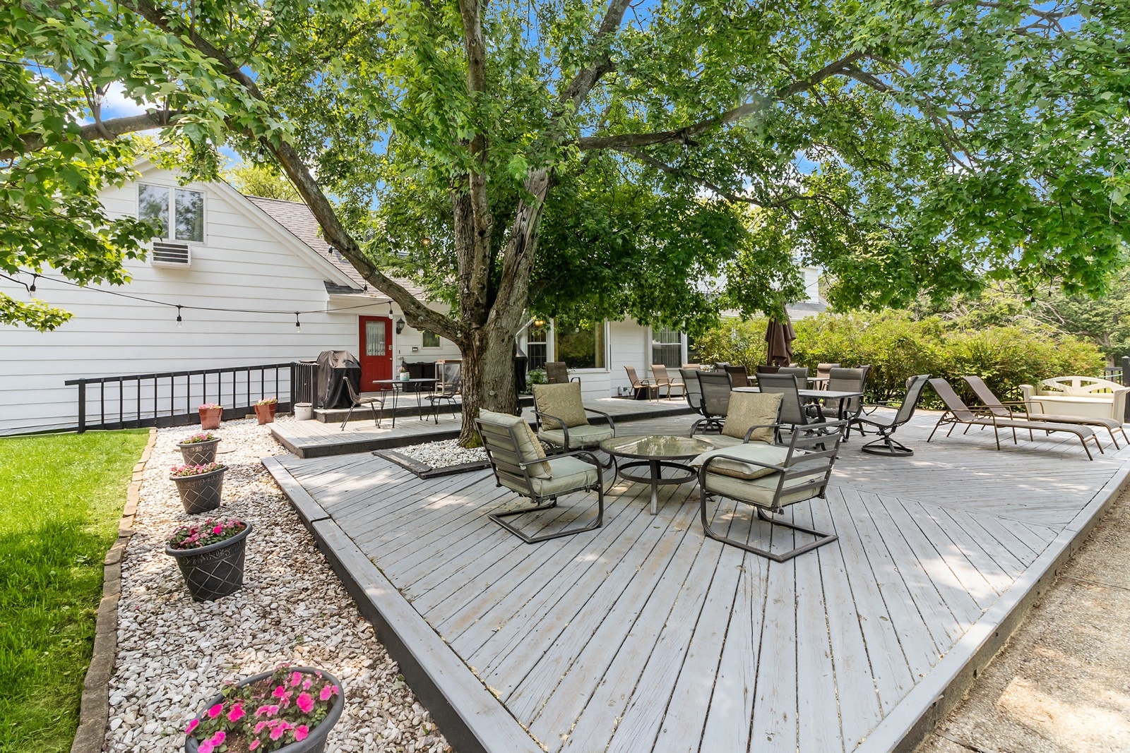 8612 Crystal Springs Road Woodstock, IL 60098 - Photo 33 of 45 a view of a patio with dining table and chairs with wooden floor and fence