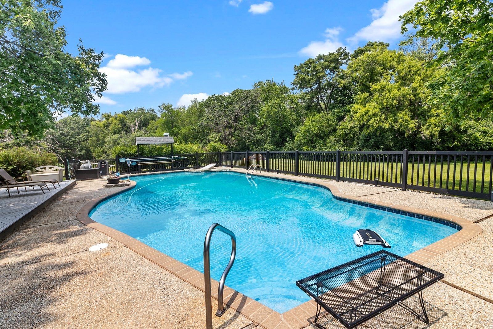 8612 Crystal Springs Road Woodstock, IL 60098 - Photo 35 of 45 a swimming pool with some trees in the background
