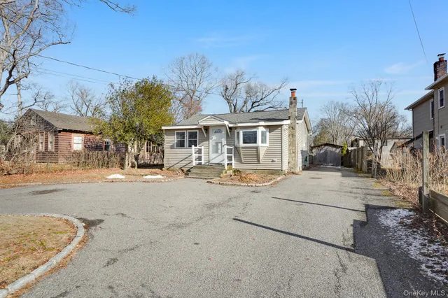 a patio with a table and chairs under an umbrella