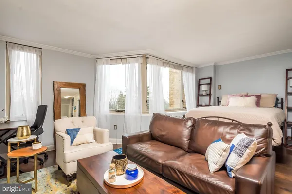 a bedroom with furniture and a large window