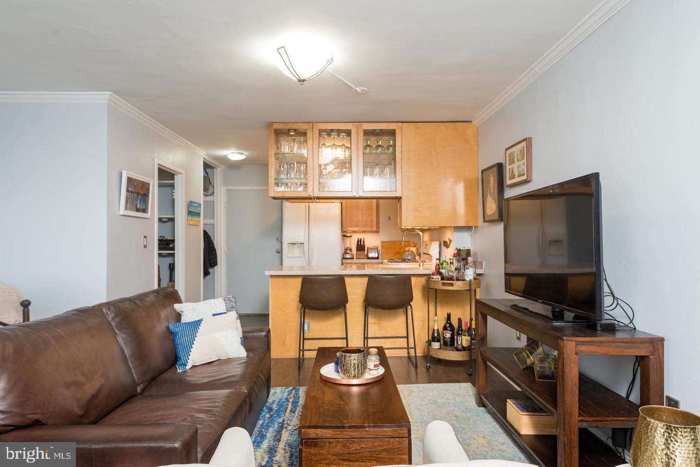 2800 Wisconsin Avenue Northwest, Unit 510 Washington, DC 20007 - Photo 11 of 20 a living room with furniture and a flat screen tv