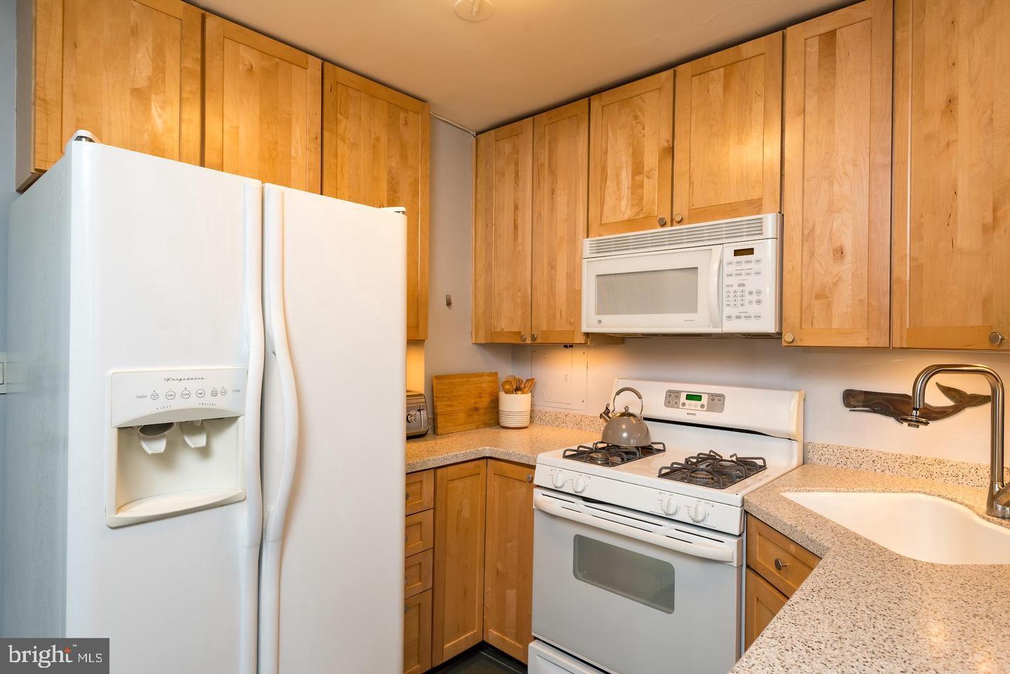 2800 Wisconsin Avenue Northwest, Unit 510 Washington, DC 20007 - Photo 6 of 20 a kitchen with a sink a stove and a refrigerator