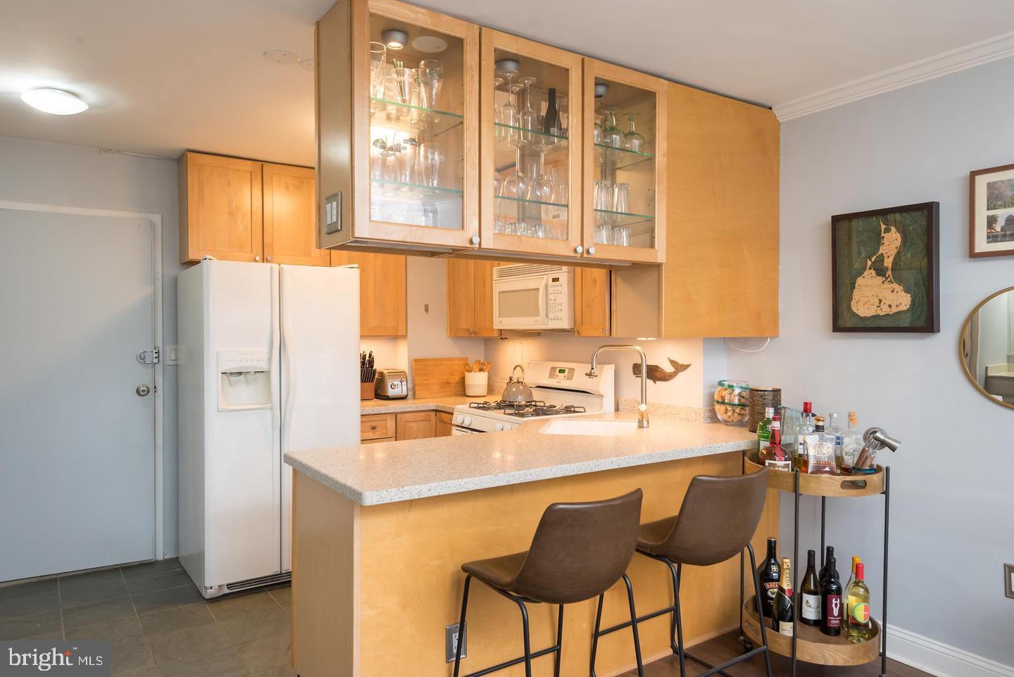 2800 Wisconsin Avenue Northwest, Unit 510 Washington, DC 20007 - Photo 8 of 20 a kitchen with a sink cabinets and dining table chair