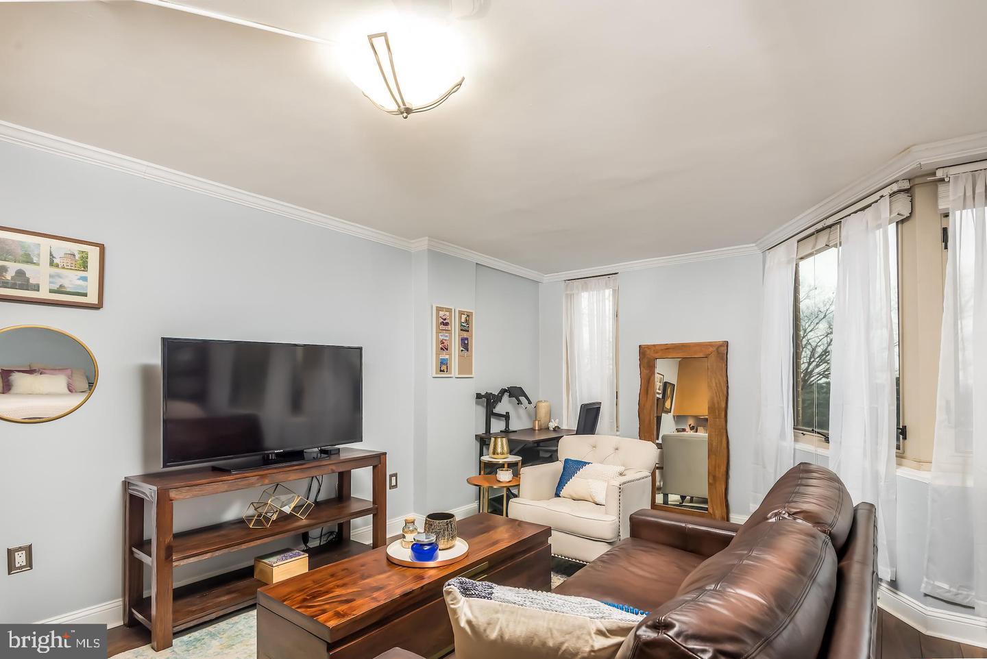 2800 Wisconsin Avenue Northwest, Unit 510 Washington, DC 20007 - Photo 9 of 20 a living room with furniture and a flat screen tv