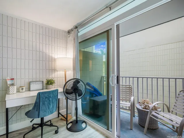 a view of a hallway with furniture and a potted plant