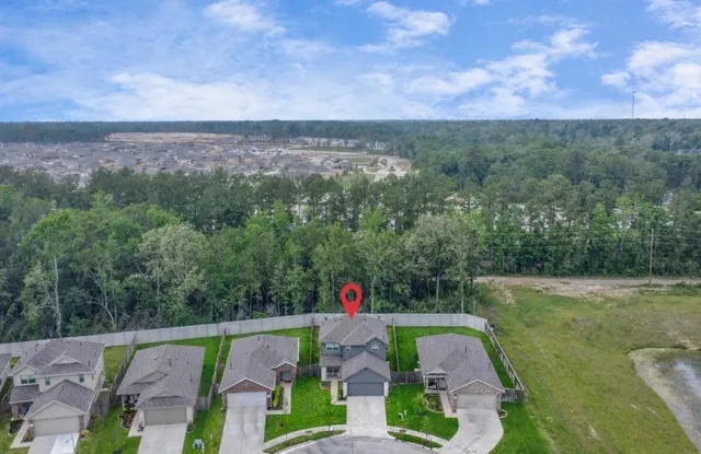 an aerial view of a houses with trees