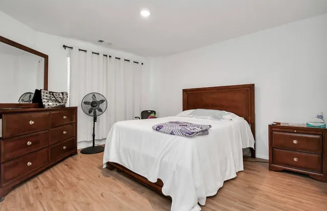 a bedroom with a bed and a dresser