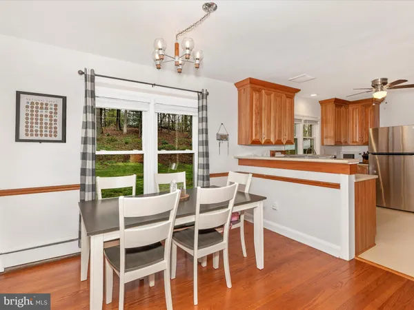 a kitchen with stainless steel appliances granite countertop a refrigerator a sink dishwasher a stove with wooden cabinets