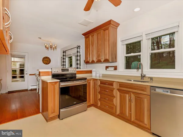 a kitchen with stainless steel appliances granite countertop a refrigerator a sink and dishwasher