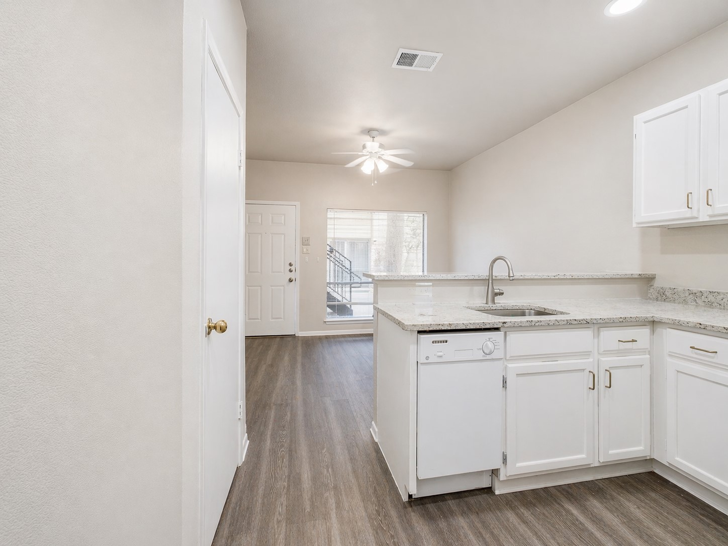 2815 Rio Grande Street, Unit 101 Austin, TX 78705 - Photo 3 of 14 a kitchen with sink cabinets and wooden floor