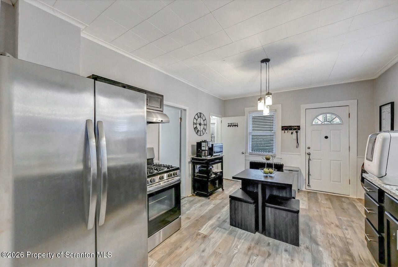 641 East Elm Street Scranton, PA 18505 - Photo 12 of 59 a kitchen with stainless steel appliances a refrigerator a stove a sink and a dining table with wooden floor