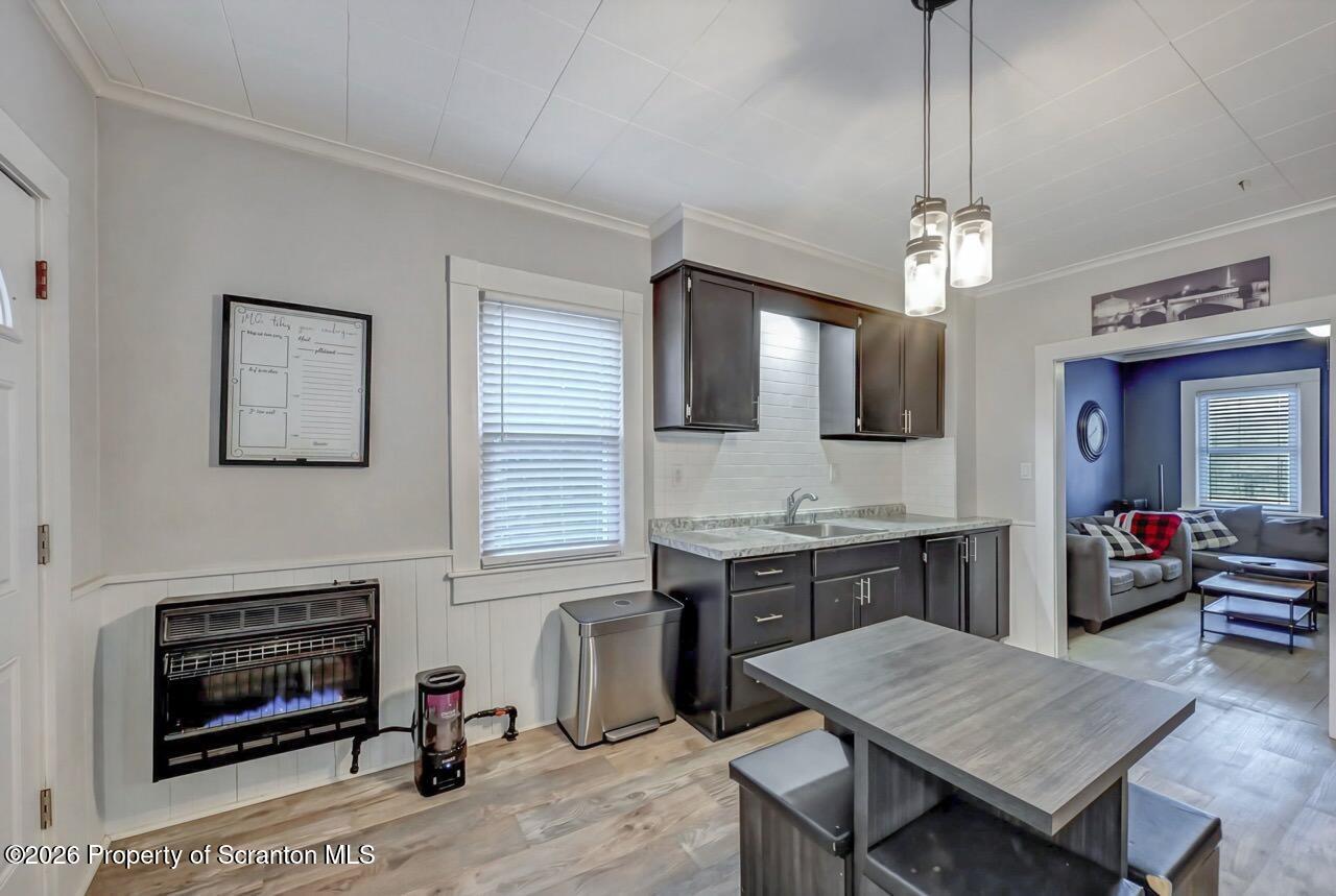 641 East Elm Street Scranton, PA 18505 - Photo 15 of 59 a open kitchen with stainless steel appliances granite countertop a stove top oven a sink dishwasher and wooden floor