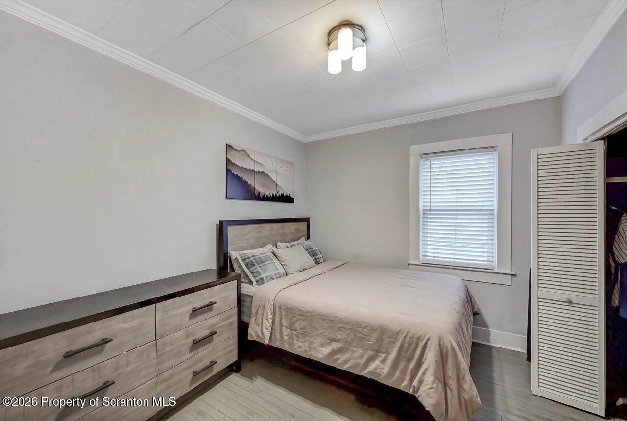 641 East Elm Street Scranton, PA 18505 - Photo 17 of 59 a bedroom with a bed and a chandelier