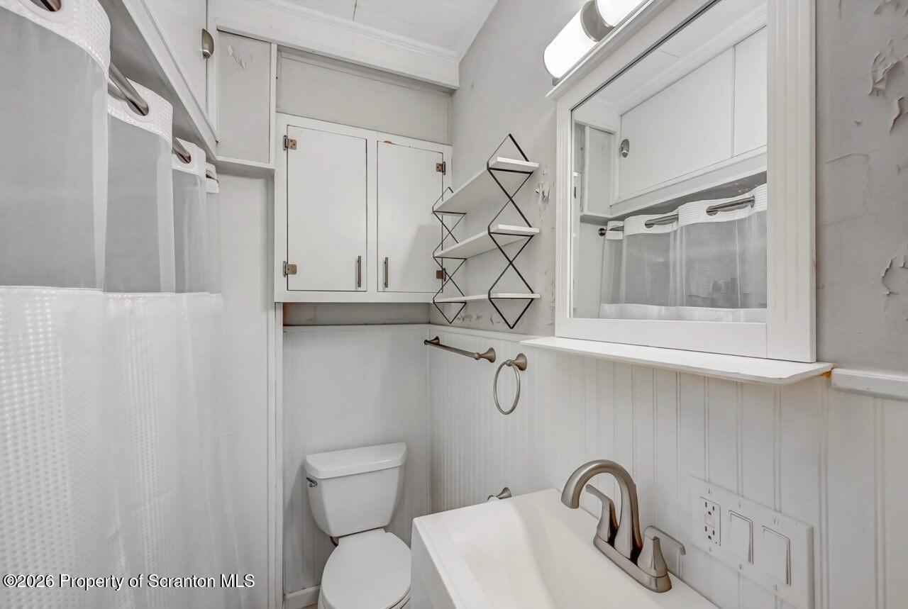 641 East Elm Street Scranton, PA 18505 - Photo 22 of 59 a bathroom with a sink and mirror with toilet