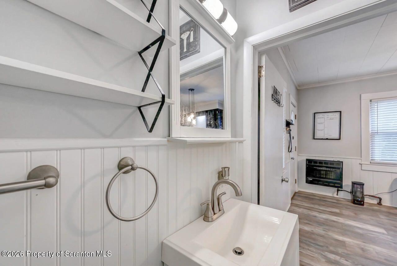641 East Elm Street Scranton, PA 18505 - Photo 23 of 59 a bathroom with a sink a mirror and a shower