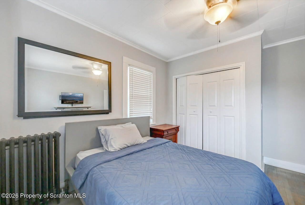 641 East Elm Street Scranton, PA 18505 - Photo 25 of 59 a bedroom with a bed and a mirror