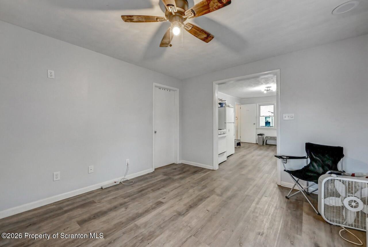 641 East Elm Street Scranton, PA 18505 - Photo 38 of 59 an empty room with wooden floor fan and windows