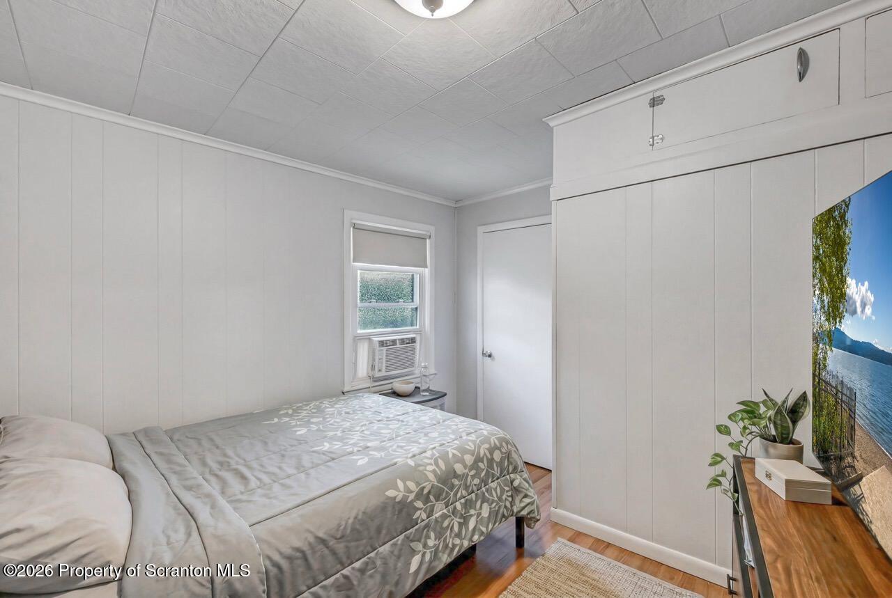 641 East Elm Street Scranton, PA 18505 - Photo 40 of 59 a bedroom with a bed and a potted plant