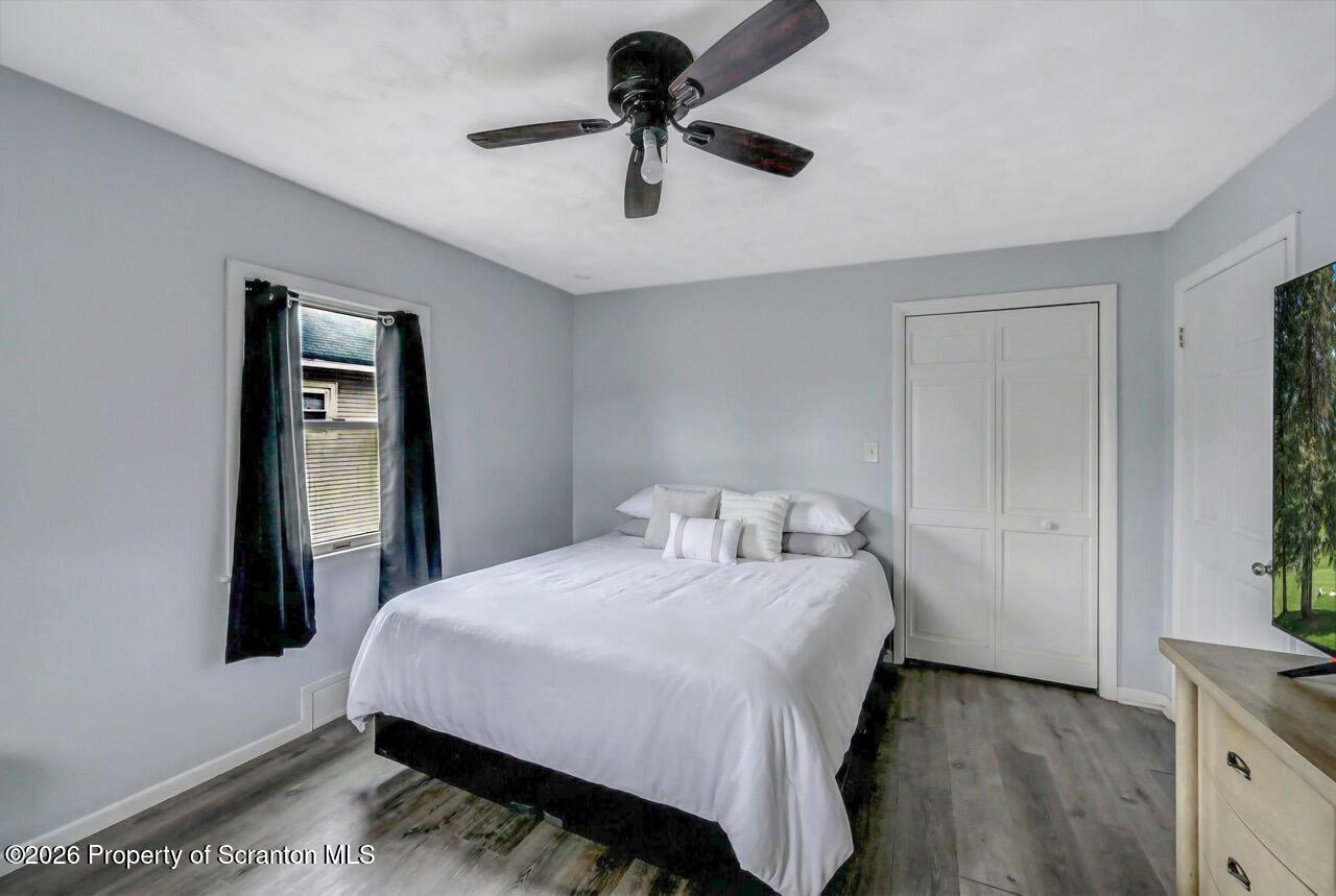 641 East Elm Street Scranton, PA 18505 - Photo 44 of 59 a bedroom with a bed and a chandelier