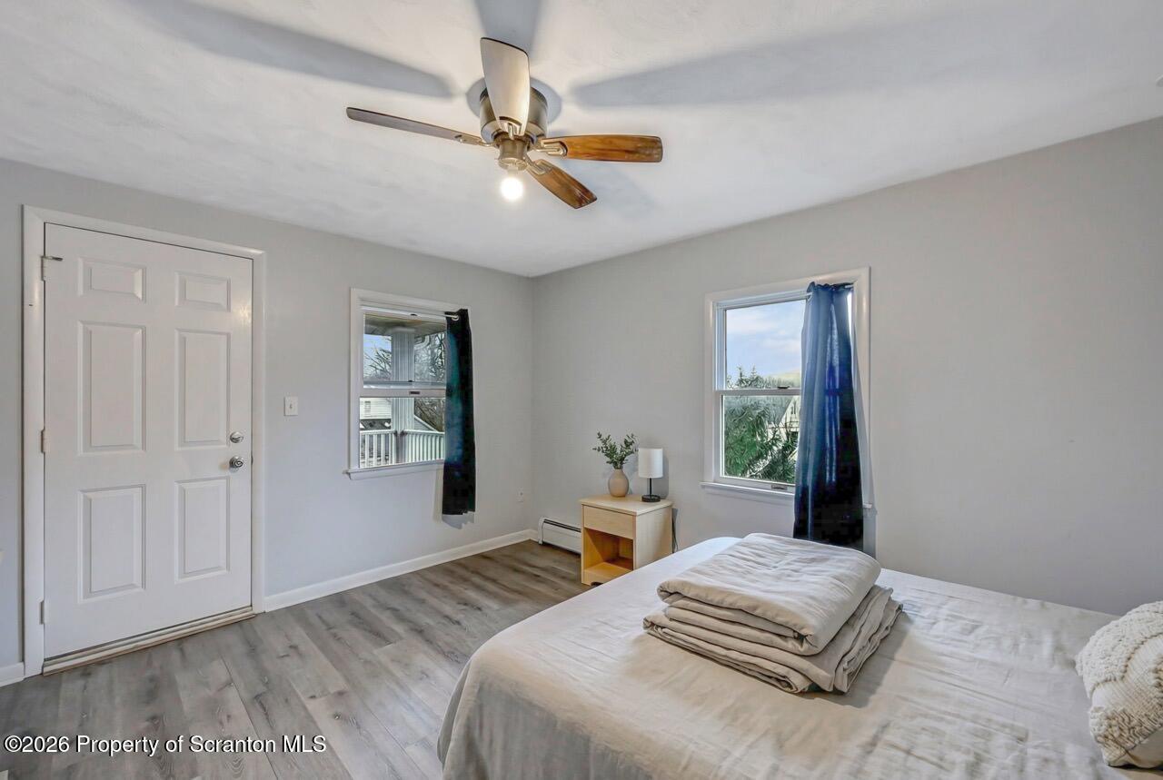 641 East Elm Street Scranton, PA 18505 - Photo 45 of 59 a bedroom with a large bed and a chandelier