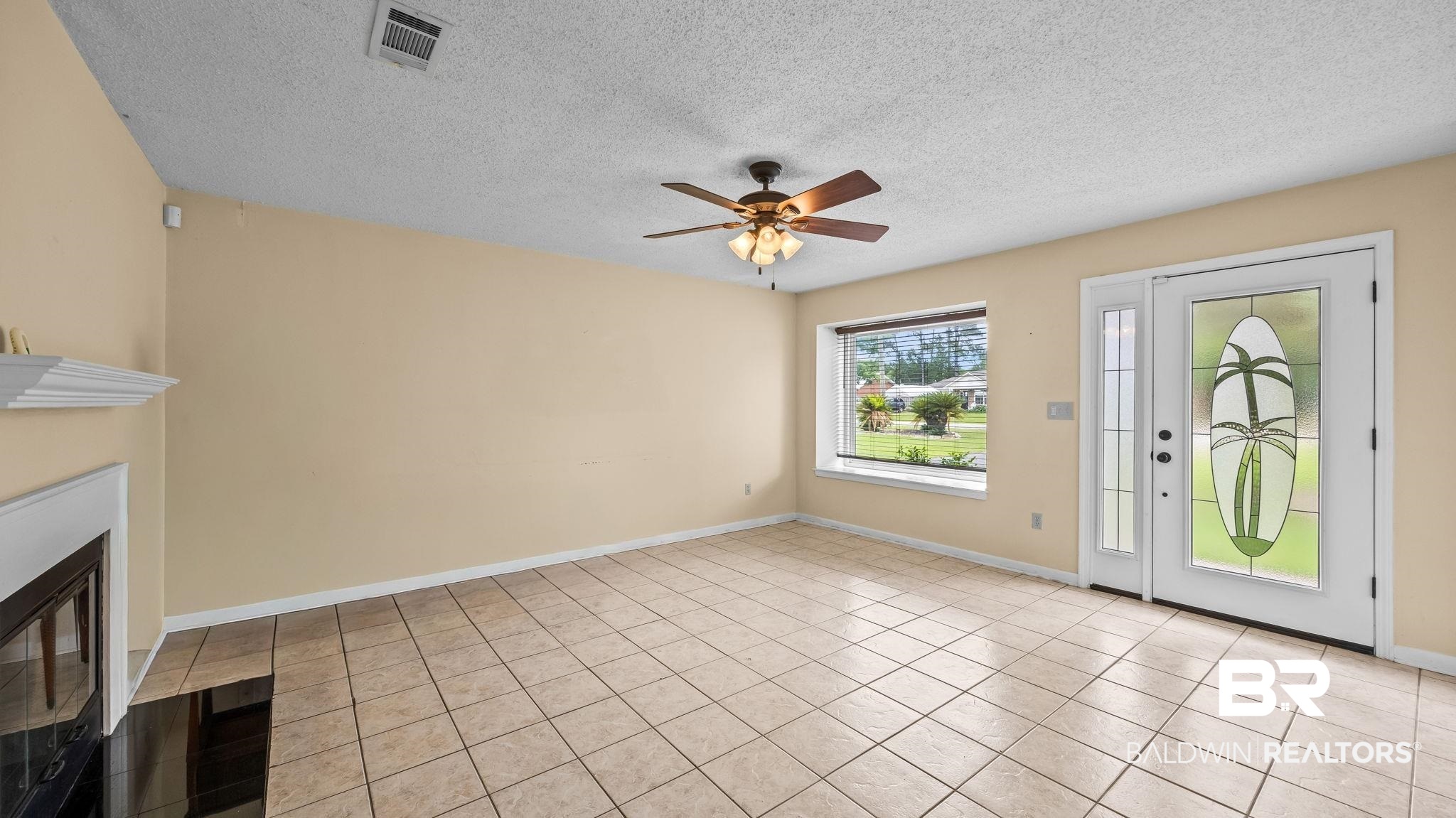 15096 Highland Circle Foley, AL 36535 - Photo 11 of 52 Spacious interior featuring neutral wall tones, large format tile flooring, and a decorative ceiling fan
