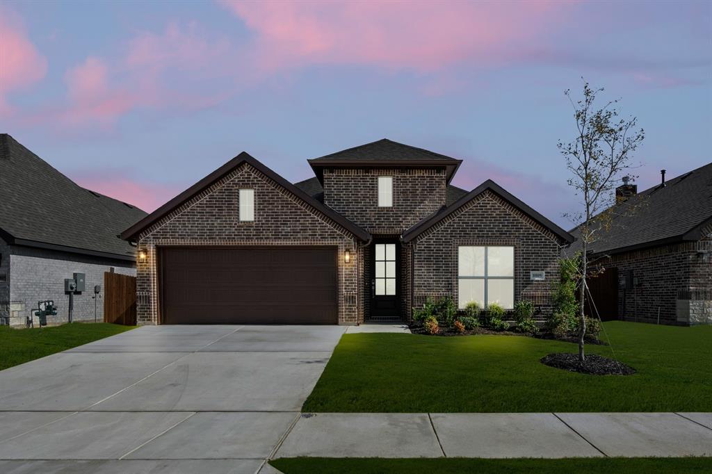 10809 Rothland Street Crowley, TX 76036 - Photo 1 of 30 a front view of a house with a yard and garage