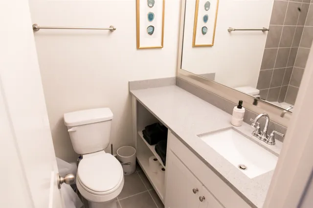 a white toilet sitting next to a bathroom sink