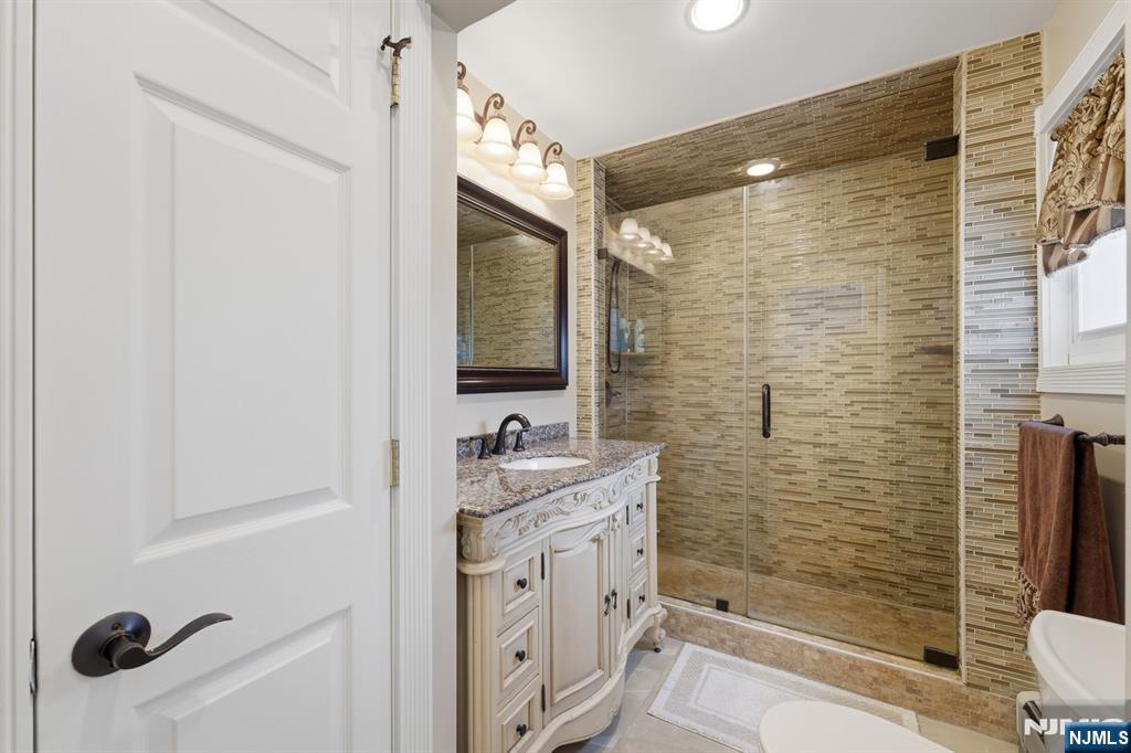385 Berkeley Avenue Bloomfield, NJ 07003 - Photo 12 of 39 a bathroom with a sink a toilet and shower