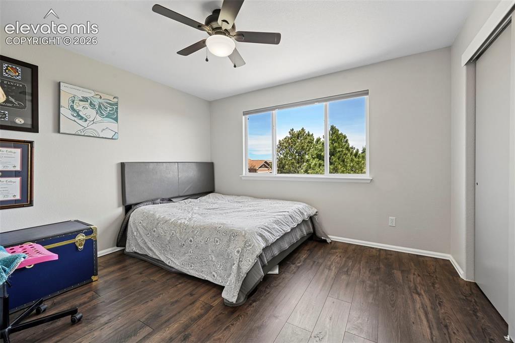 10643 Pictured Rocks Drive Peyton, CO 80831 - Photo 18 of 37 a bedroom with a bed and a chandelier