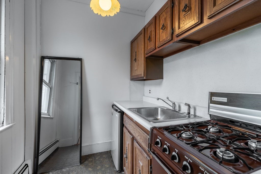 32 High Street Boston, MA 02129 - Photo 11 of 38 a kitchen with stainless steel appliances granite countertop a stove and a sink