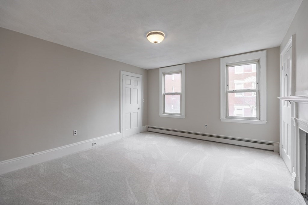 32 High Street Boston, MA 02129 - Photo 19 of 38 an empty room with windows and closet