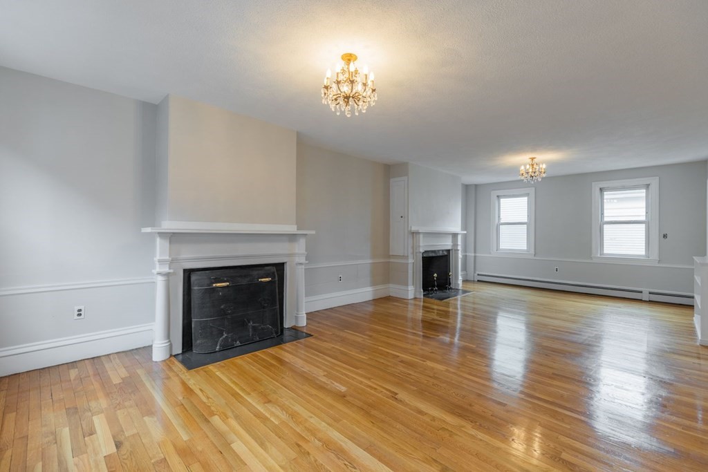 32 High Street Boston, MA 02129 - Photo 2 of 38 a view of empty room with fireplace and wooden floor
