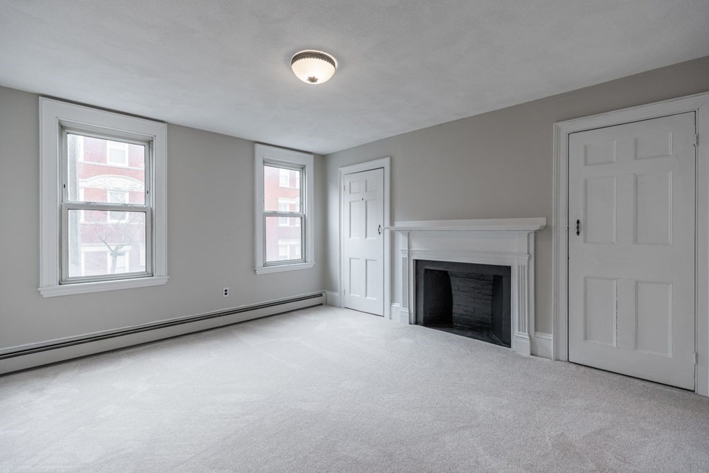 32 High Street Boston, MA 02129 - Photo 21 of 38 an empty room with windows and fireplace