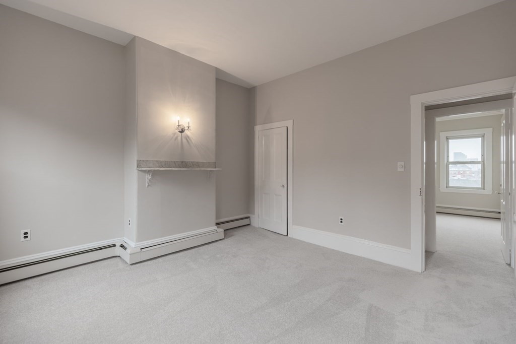 32 High Street Boston, MA 02129 - Photo 25 of 38 an empty room with an entryway and white doors