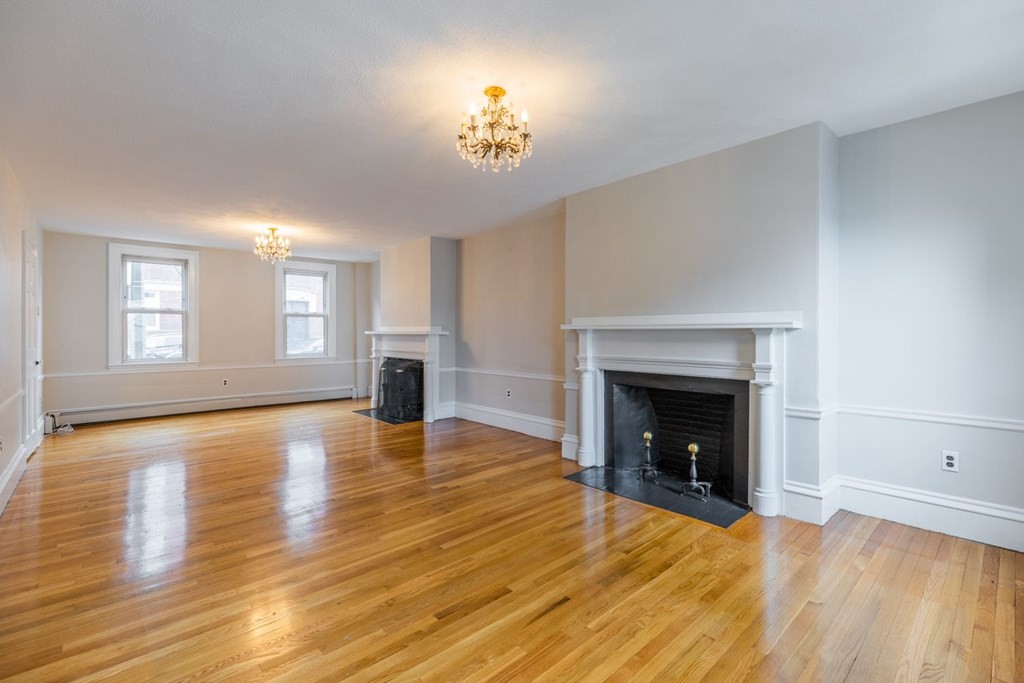 32 High Street Boston, MA 02129 - Photo 4 of 38 a view of empty room with fireplace and wooden floor