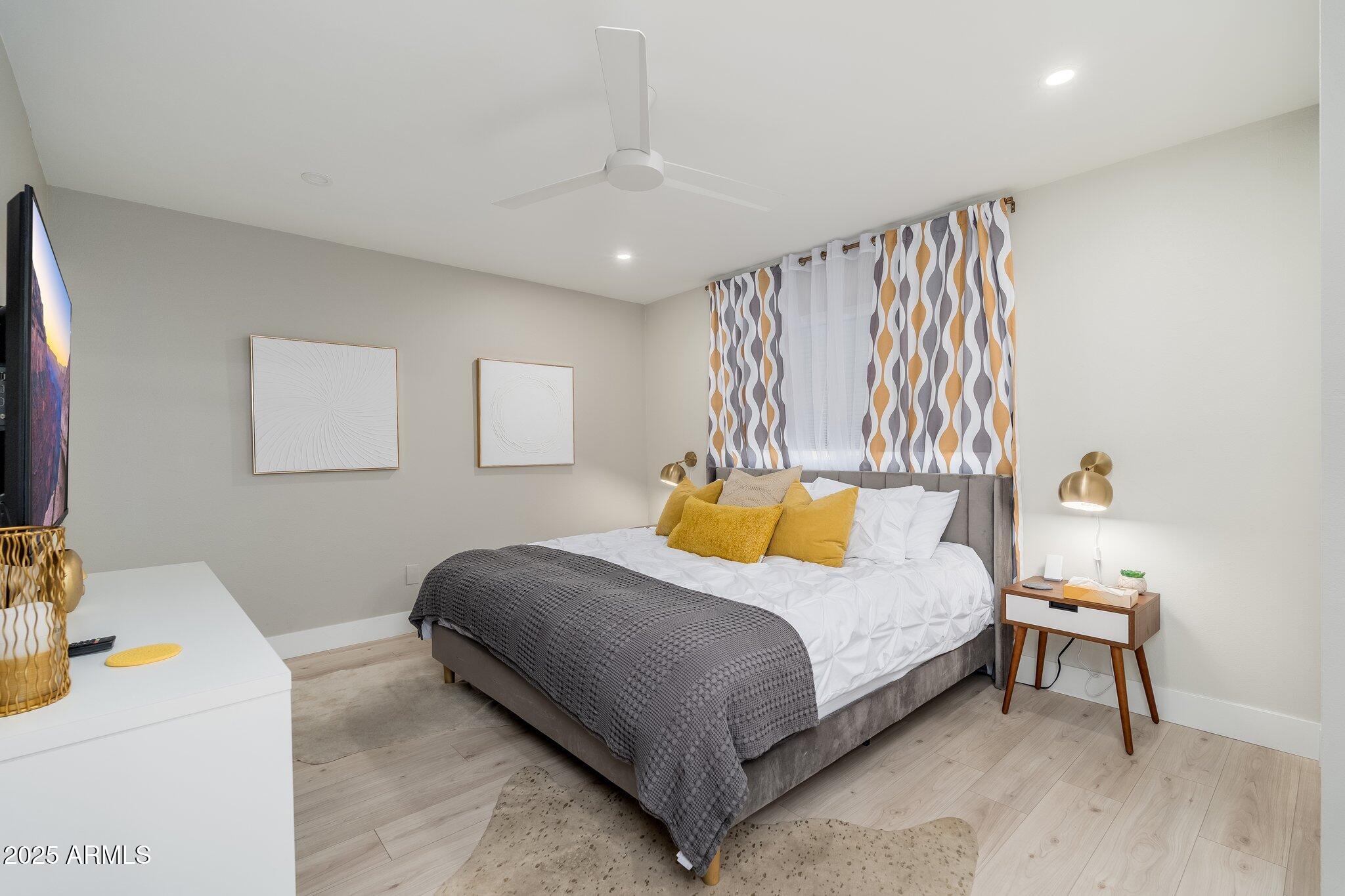 6957 East Osborn Road, Unit A Scottsdale, AZ 85251 - Photo 14 of 29 a bedroom with a bed and a table in it