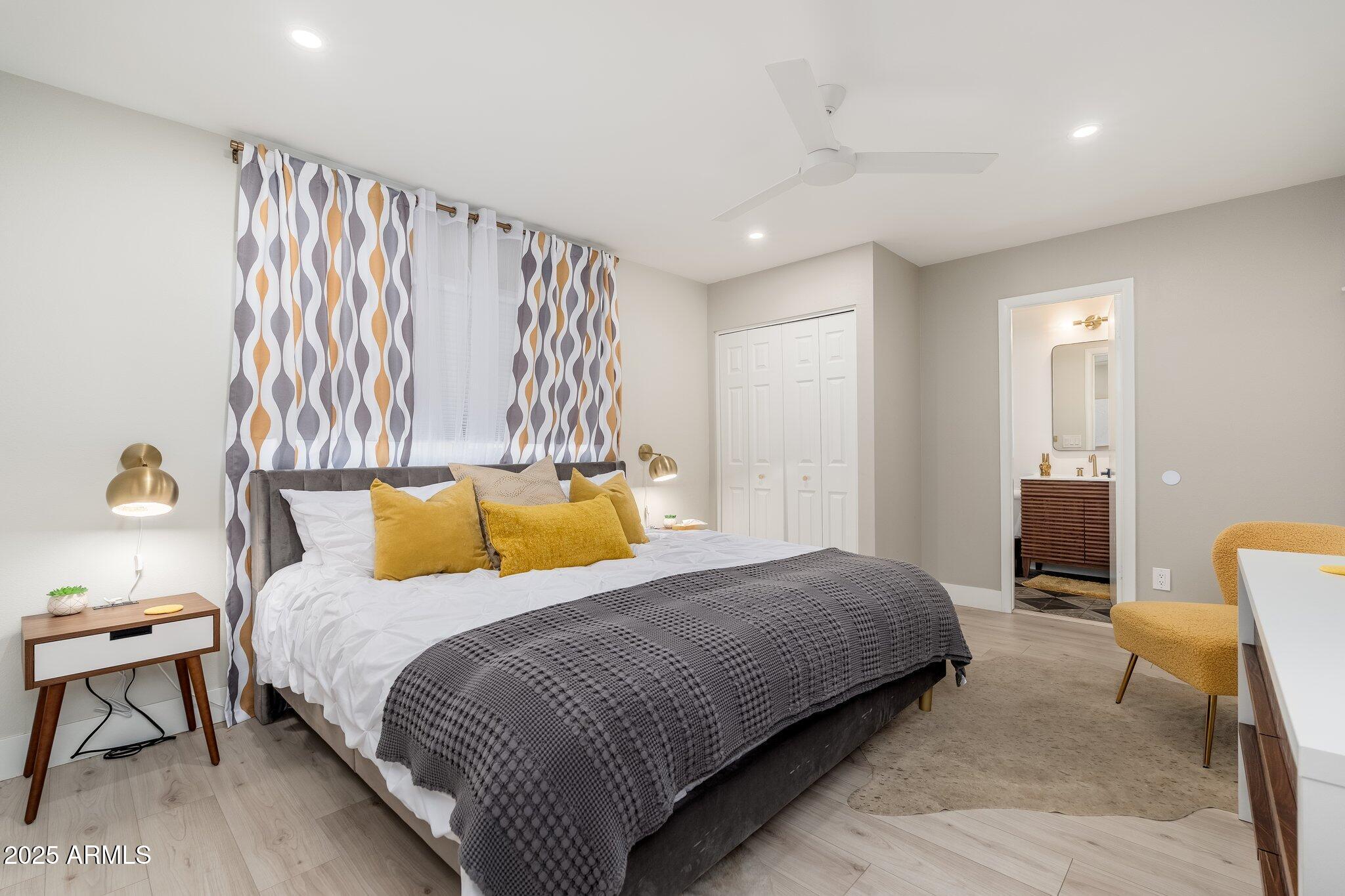 6957 East Osborn Road, Unit A Scottsdale, AZ 85251 - Photo 15 of 29 a bed room with a bed and a chair