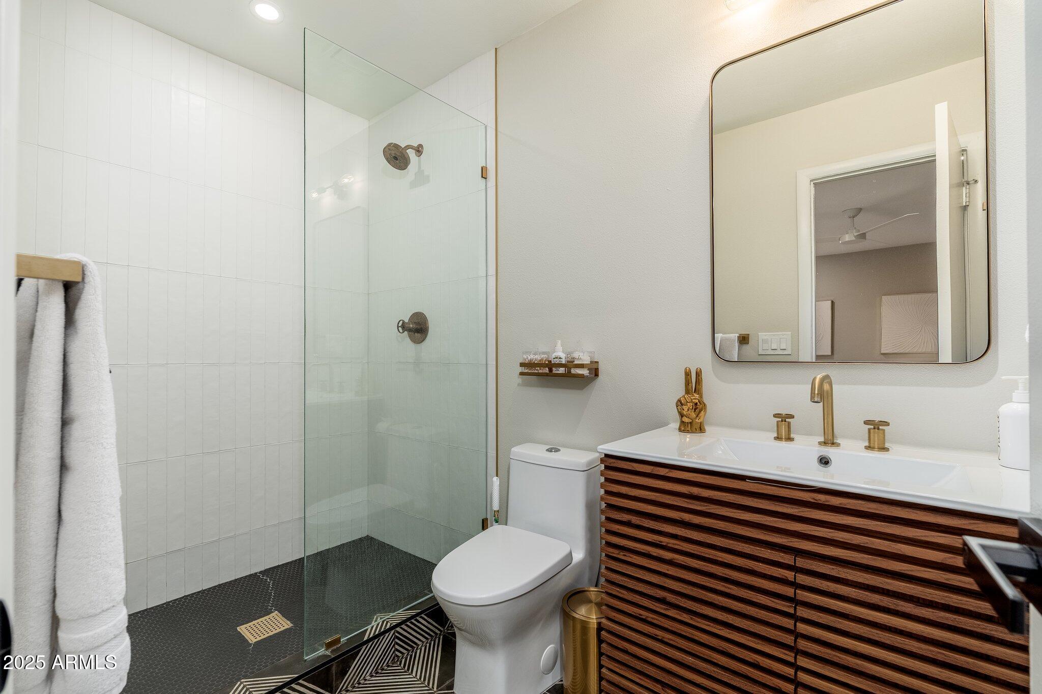 6957 East Osborn Road, Unit A Scottsdale, AZ 85251 - Photo 16 of 29 a bathroom with a sink toilet and shower