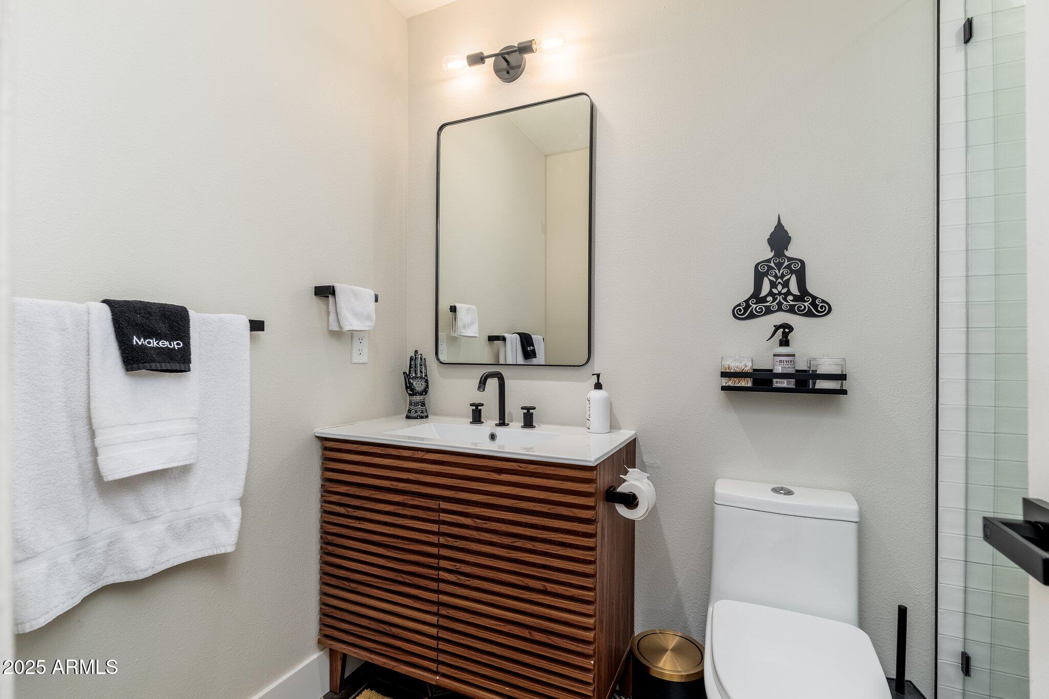6957 East Osborn Road, Unit A Scottsdale, AZ 85251 - Photo 17 of 29 a bathroom with a sink and a mirror