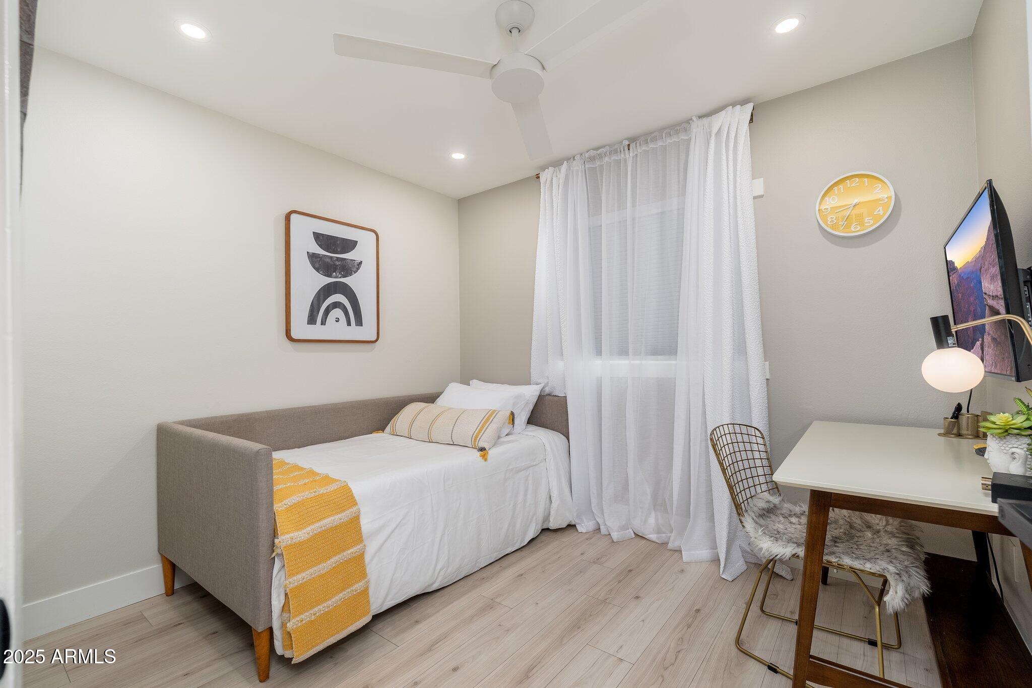 6957 East Osborn Road, Unit A Scottsdale, AZ 85251 - Photo 19 of 29 a bedroom with bed and a table