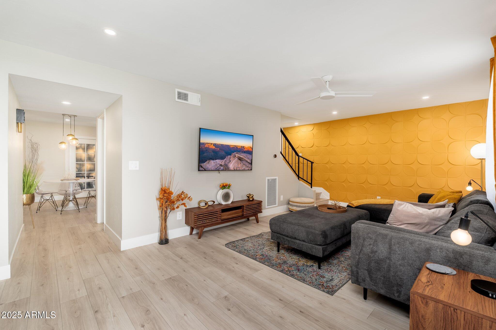 6957 East Osborn Road, Unit A Scottsdale, AZ 85251 - Photo 2 of 29 a living room with furniture and a flat screen tv