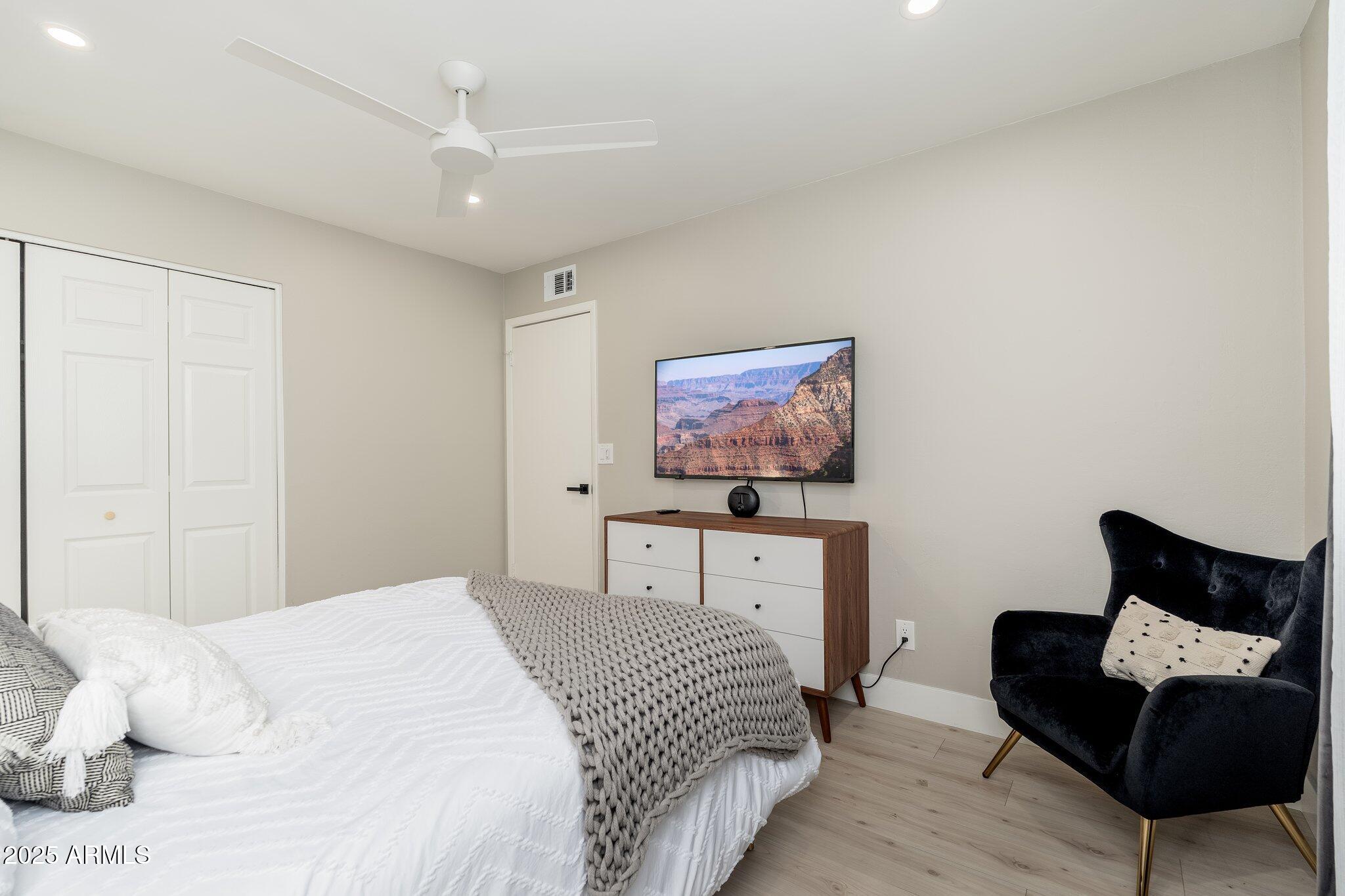 6957 East Osborn Road, Unit A Scottsdale, AZ 85251 - Photo 21 of 29 a bedroom with a bed and a couch