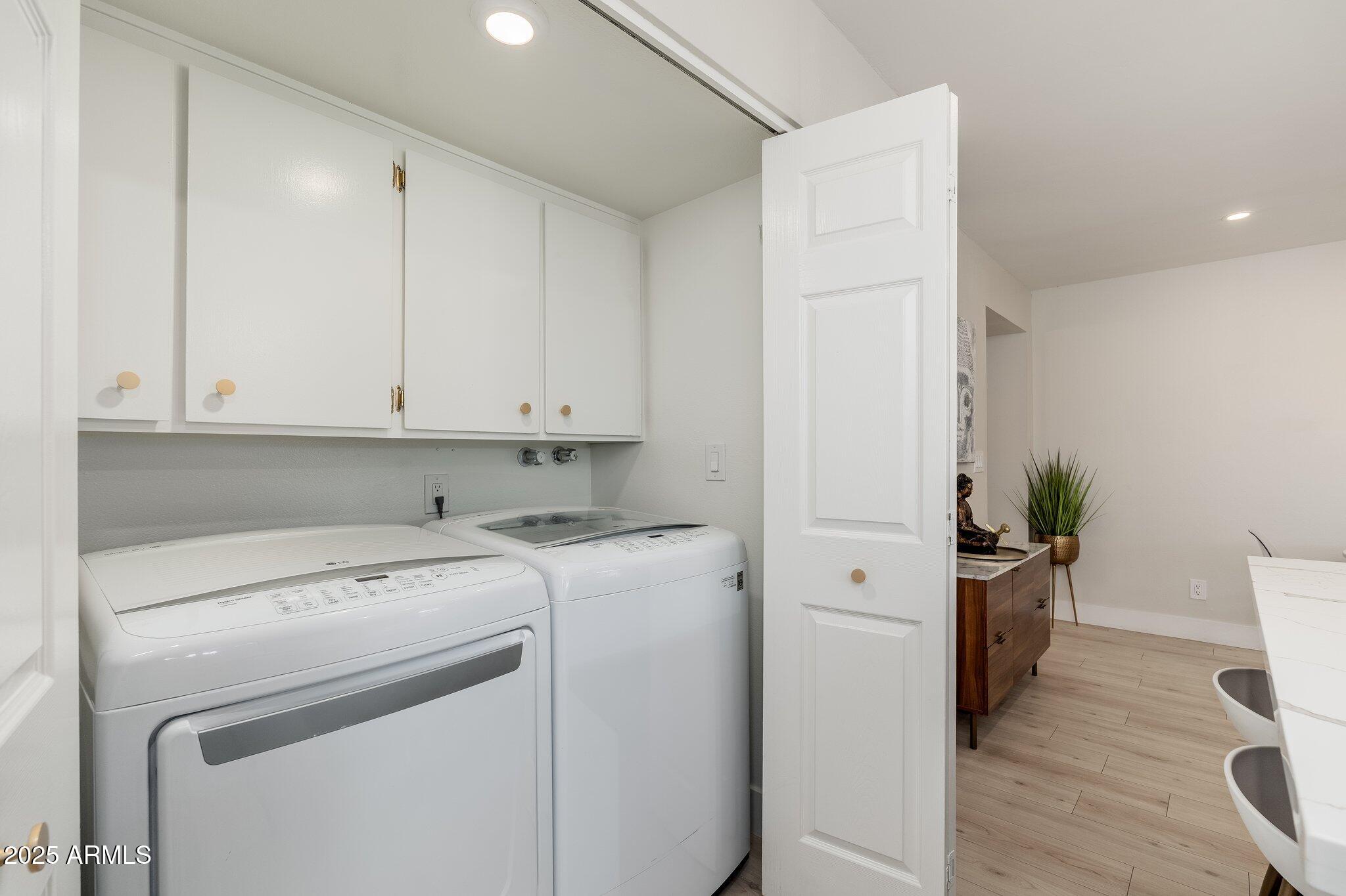 6957 East Osborn Road, Unit A Scottsdale, AZ 85251 - Photo 22 of 29 a view of washer and dryer with wooden floor