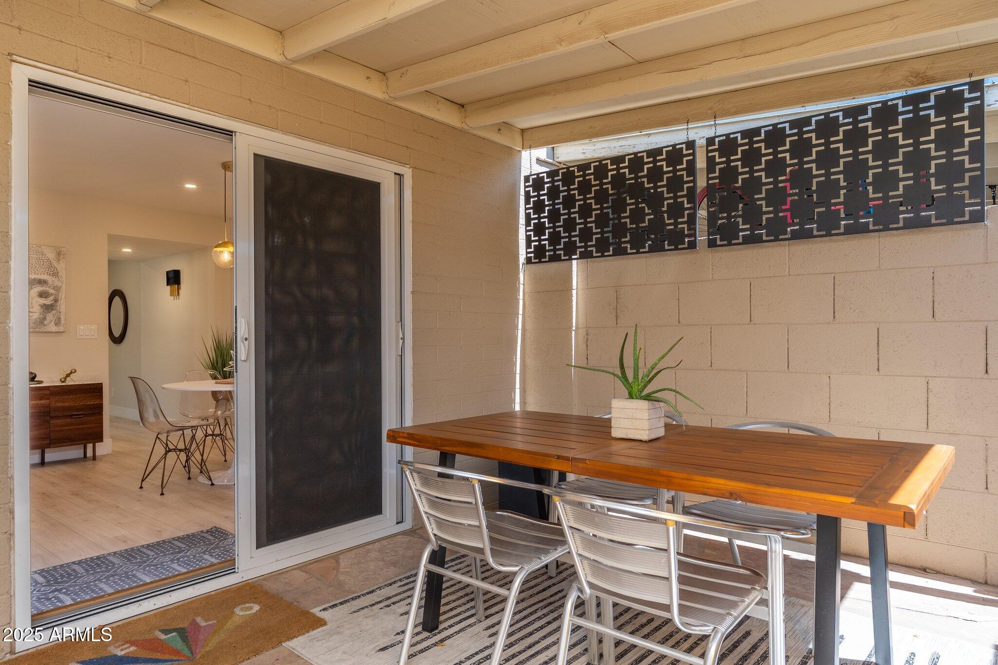 6957 East Osborn Road, Unit A Scottsdale, AZ 85251 - Photo 25 of 29 a view of a dining room with furniture and wooden floor