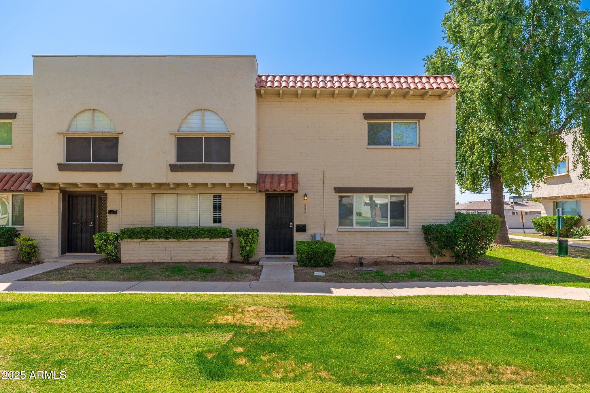 6957 East Osborn Road, Unit A Scottsdale, AZ 85251 - Photo 27 of 29 a front view of a house with a yard