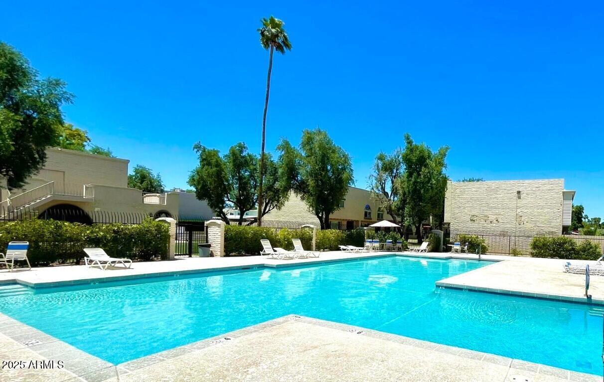 6957 East Osborn Road, Unit A Scottsdale, AZ 85251 - Photo 28 of 29 a view of a garden and swimming pool